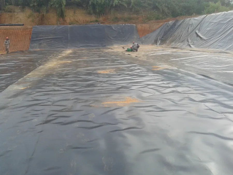Equipe GLX soldando painéis de geomembrana PEAD em reservatório